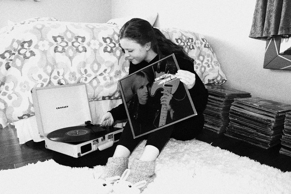 My self portrait sitting with a record player